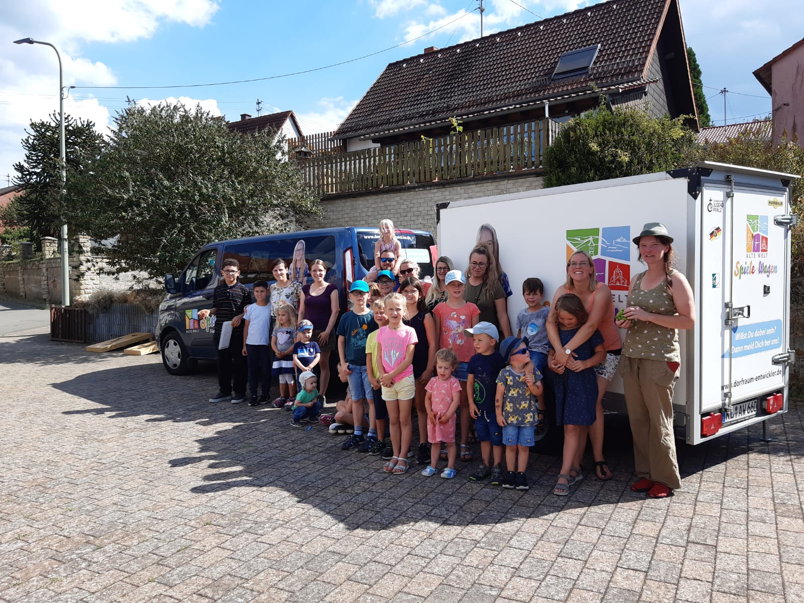 Kinder und Erwachsene vor dem Spiele-Wagen-Gespann